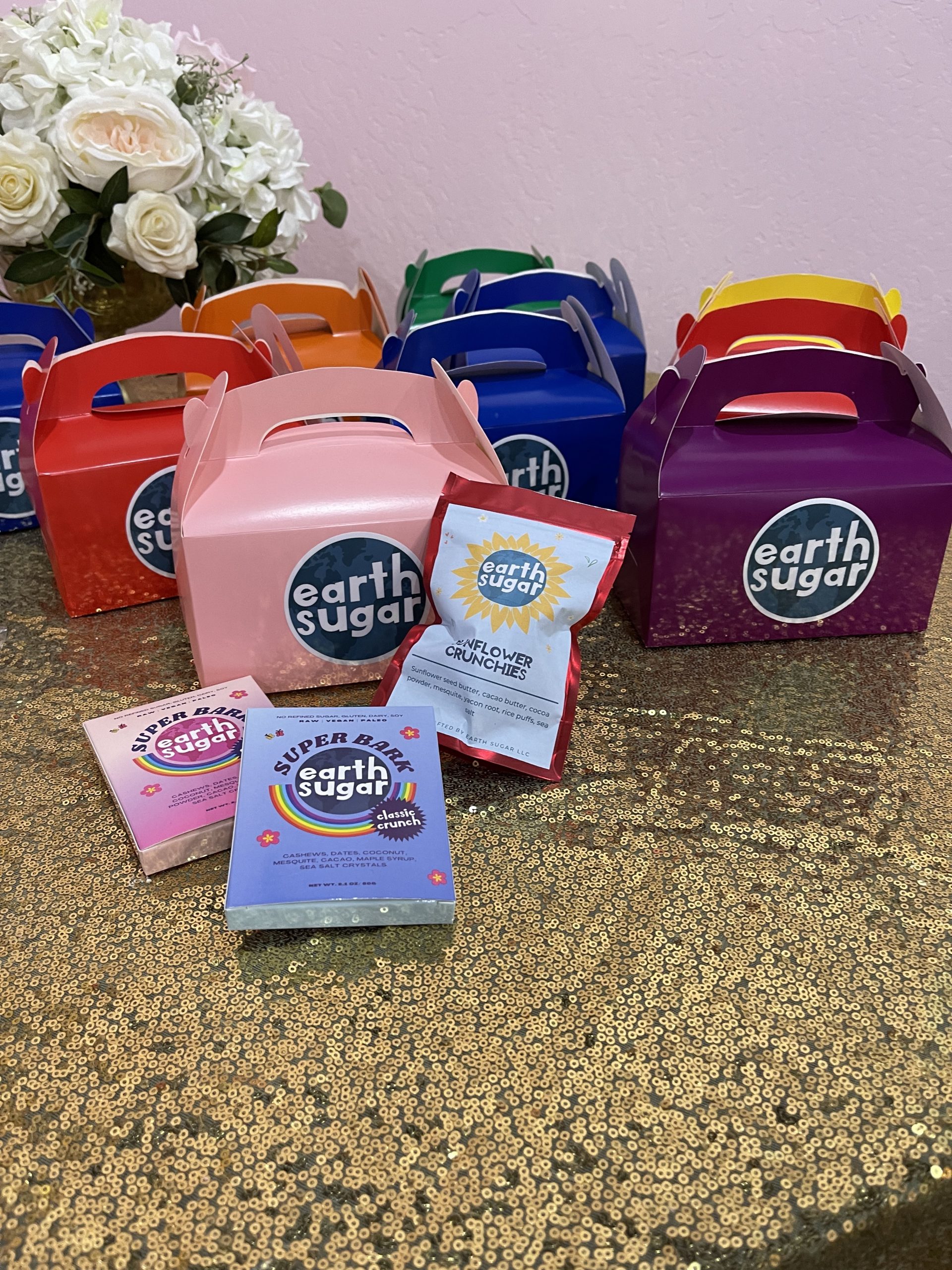 Earth Sugar branded boxes on a table with the treats displayed.
