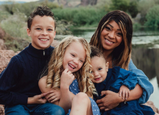 mom with her three kids in a family portrait set outside by the Salt River in Mesa, AZ