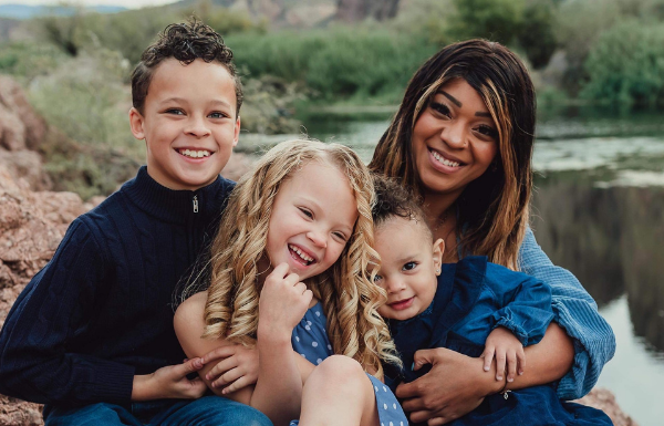 mom with her three kids in a family portrait set outside by the Salt River in Mesa, AZ